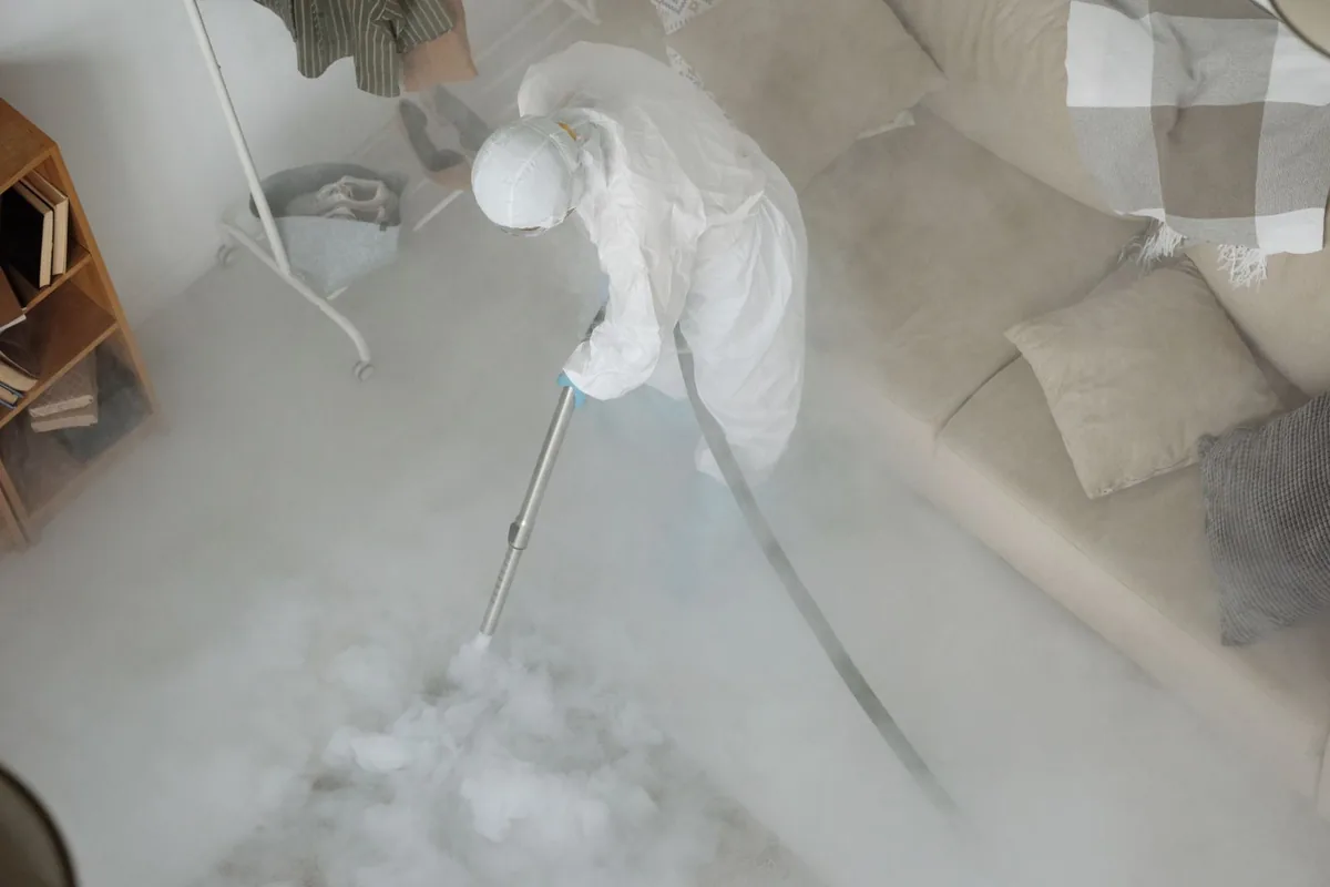 Biohazard cleanup technician in protective equipment, Moores Mill, AL